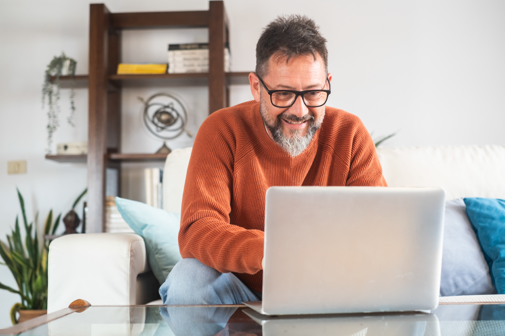 Man looking at his laptop in a home setting